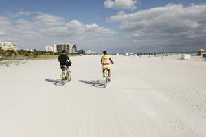 back, beach, couple, cycling, day, eye level view, Florida, Miami, people, summer, sunny, The United States