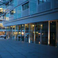 architecture, artificial lighting, building, dusk, England, eye level view, facade, glass, London, office, pavement, The United Kingdom, truck, urban