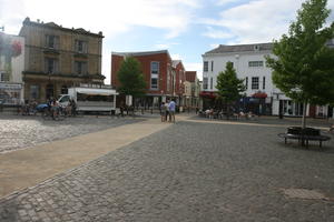 Abingdon, building, cycling, day, England, eye level view, furniture, group, natural light, pavement, people, square, standing, summer, sunny, The United Kingdom