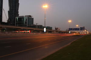 artificial lighting, cityscape, Dubai, Dubayy, dusk, eye level view, flyover, lamppost, outdoor lighting, road, The United Arab Emirates