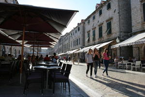 afternoon, backlight, cafe, canopy, casual, chair, Croatia, day, Dubrovacko-Neretvanska, Dubrovnik, eye level view, furniture, group, people, square, summer, sunny, table, umbrella, walking