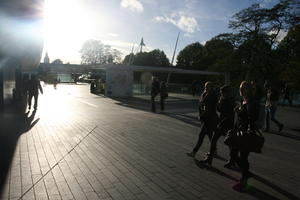 autumn, city, day, dusk, England, eye level view, group, London, pavement, people, side, square, sunny, The United Kingdom, urban, walking, woman