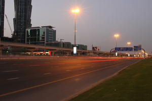 artificial lighting, cityscape, Dubai, Dubayy, dusk, eye level view, flyover, lamppost, outdoor lighting, road, sign, The United Arab Emirates