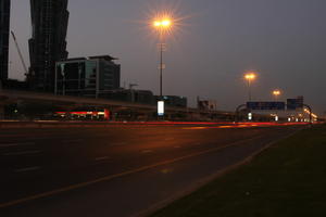 artificial lighting, cityscape, Dubai, Dubayy, dusk, eye level view, flyover, lamppost, outdoor lighting, road, The United Arab Emirates