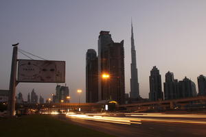 artificial lighting, cityscape, Dubai, Dubayy, dusk, eye level view, flyover, lamppost, outdoor lighting, road, sign, skyscraper, The United Arab Emirates