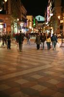 artificial lighting, autumn, evening, eye level view, group, Madrid, night, people, Spain, street