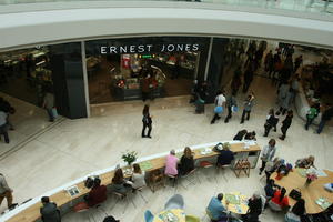 above, cafe, day, eating, England, group, indoor lighting, interior, London, mall, natural light, people, retail, shop, shopping centre, sign, sitting, The United Kingdom, walking