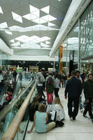 ceiling, day, England, eye level view, group, indoor lighting, interior, London, mall, natural light, people, retail, shop, shopping, shopping centre, sitting, The United Kingdom, walking