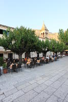 cafe, chair, Croatia, day, dusk, eye level view, furniture, group, Makarska, object, people, potted plant, sitting, Splitsko-Dalmatinska, square, table, tree, vegetation