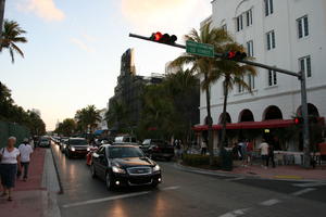 artificial lighting, bar, building, car, evening, eye level view, Florida, Miami, object, palm, road, sign, The United States, traffic light, transport, vegetation