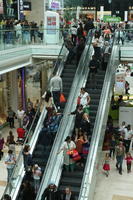 day, elevated, England, escalator, eye level view, group, indoor lighting, interior, London, mall, natural light, people, retail, shop, shopping, shopping centre, The United Kingdom, walking