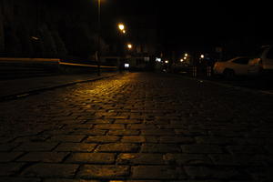 artificial lighting, city lights, eye level view, Kalisz, lowered, night, outdoor lighting, pavement, Poland, street, urban, wet, Wielkopolskie, winter