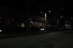 artificial lighting, city, city lights, England, eye level view, London, night, outdoor lighting, pavement, restaurant, sign, street, The United Kingdom, urban