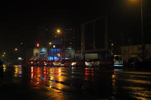 artificial lighting, car, city, city lights, eye level view, Kalisz, night, outdoor lighting, Poland, reflected, silhouette, street, traffic, Wielkopolskie