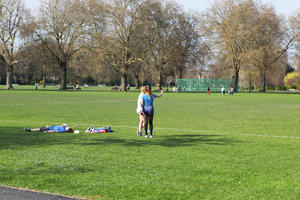 day, deciduous, England, eye level view, grass, group, laying, London, park, people, sport, sporty, spring, standing, sunny, The United Kingdom, tree