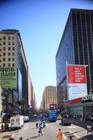 advertisement, afrocarribean, building, bus, business, car, day, elevated, man, Manhattan, New York, people, standing, street, summer, sunny, The United States, van, walking