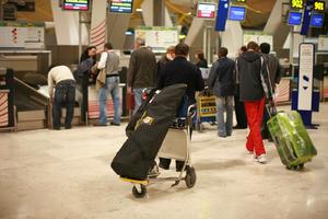 airport, artificial lighting, autumn, Barajas Airport, evening, eye level view, group, indoor lighting, interior, kiosk, Madrid, people, sign, Spain