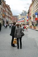 Amiens, couple, day, eye level view, flag, France, group, overcast, people, Picardie, shopping, street