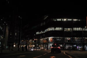 artificial lighting, building, car, city, city lights, England, eye level view, facade, London, night, outdoor lighting, street, The United Kingdom, urban