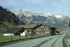 bright, chalet, cliffs, day, eye level view, mountain, nature, outdoors, road, rocks, snow, sunlight, sunny, Switzerland, tarmac, Valais, winter