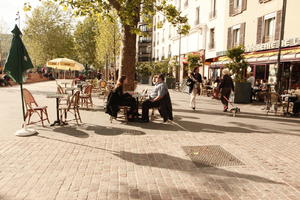 cafe, casual, chair, day, eye level view, France, furniture, group, Ile-De-France, Paris, people, sitting, spring, square, sunny, table, umbrella, walking