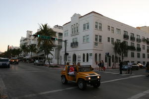 architecture, building, car, day, dusk, eye level view, Florida, group, jeep, Miami, object, palm, people, road, The United States, traffic light, transport, vegetation, walking