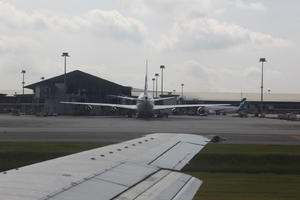 airplane, airport, autumn, cloudy, day, eye level view, Malaysia, Malaysia, natural light, wing