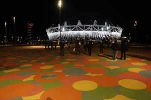 artificial lighting, casual, England, eye level view, group, London, night, outdoor lighting, pavement, people, square, stadium, summer, The United Kingdom, walking