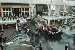 cafe, day, eating, elevated, England, escalator, group, indoor lighting, interior, London, mall, natural light, people, shopping, shopping centre, sitting, The United Kingdom, walking