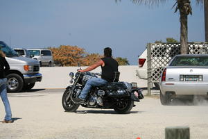 back, car, day, eye level view, Florida, man, Miami, motorcycling, natural light, sunny, The United States, winter