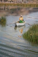 boat, day, eye level view, lake, natural light, Peru, Puno, reed, sailing, spring, woman