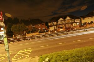 artificial lighting, England, evening, eye level view, grass, London, road, The United Kingdom, vegetation