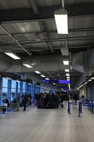 airport, artificial lighting, ceiling, crowd, England, eye level view, floor, hallway, light, London, people, queuing, sign, terminal, The United Kingdom