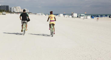 back, beach, couple, cycling, day, eye level view, Florida, Miami, people, summer, sunny, The United States