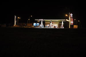 artificial lighting, city lights, eye level view, Kalisz, night, outdoor lighting, petrol station, Poland, street, urban, wet, Wielkopolskie, winter