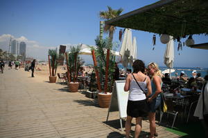 Barcelona, beach, cafe, Cataluña, day, decking, direct sunlight, eye level view, group, people, potted plant, Spain, spring, summer, sunny, woman