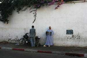 Agadir, arabic, autumn, day, eye level view, man, Morocco, sign, standing, street, sunlight, sunny, sunshine, woman