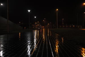 artificial lighting, city lights, eye level view, Kalisz, lowered, night, outdoor lighting, pavement, Poland, street, urban, wet, Wielkopolskie, winter