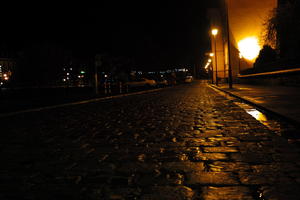 artificial lighting, city lights, eye level view, Kalisz, lowered, night, outdoor lighting, pavement, Poland, street, urban, wet, Wielkopolskie, winter