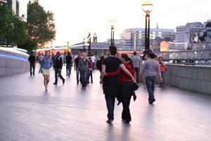 artificial lighting, back, casual, diffuse, diffused light, England, evening, eye level view, group, London, people, The United Kingdom, twilight, walking