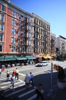 building, crossing, day, elevated, facade, man, Manhattan, New York, old, people, restaurant, retail, shop, street, summer, sunny, The United States, walking