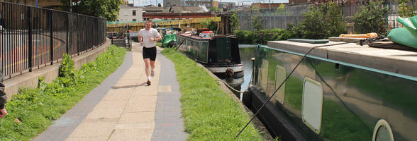 boat, canal, day, England, eye level view, front, London, male, man, path, running, spring, sunny, The United Kingdom