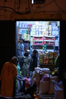 arabic, artificial lighting, autumn, baby, Essaouira, eye level view, food, market, Morocco, night, object, people, stall, woman