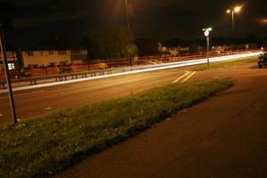 artificial lighting, England, evening, eye level view, grass, London, road, The United Kingdom, vegetation