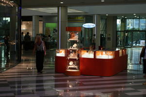 artificial lighting, Bulgaria, eye level view, floor, indoor lighting, interior, shopping centre, stall, summer, summer, Varna, walking, woman