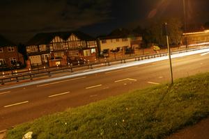 artificial lighting, England, evening, eye level view, grass, London, road, The United Kingdom, vegetation