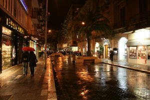 artificial lighting, Bari, couple, eye level view, Italia , night, palm, people, Puglia, retail, shop, street, vegetation, walking, winter, winter