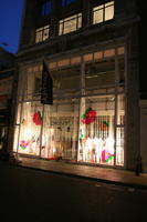 artificial lighting, England, evening, eye level view, London, night, outdoor lighting, retail, shop, shopfronts, The United Kingdom