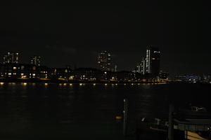 artificial lighting, city, cityscape, England, eye level view, London, night, river, riverbank, The United Kingdom