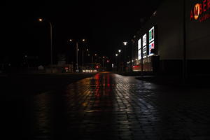 artificial lighting, city lights, eye level view, Kalisz, lowered, night, outdoor lighting, pavement, Poland, street, urban, wet, Wielkopolskie, winter